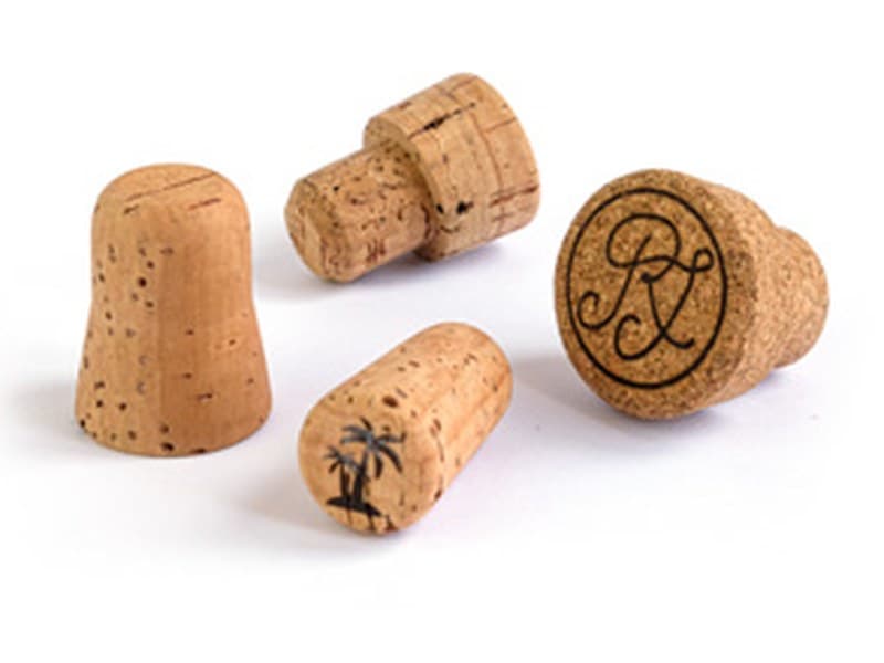 Cork bar-top stoppers with wood and engraved heads