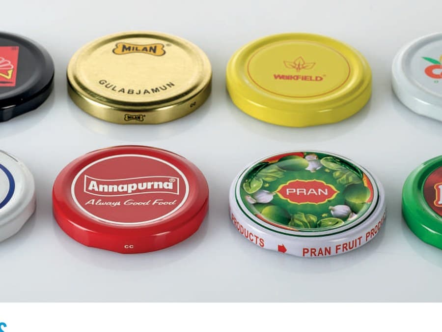 Twist-off metal lug caps decorated for food brands